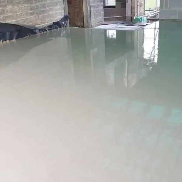 Image of liquid screed that has been applied to a ground floor inside of a building