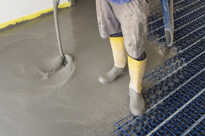 Worker pouring ready-mix concrete in a building construction